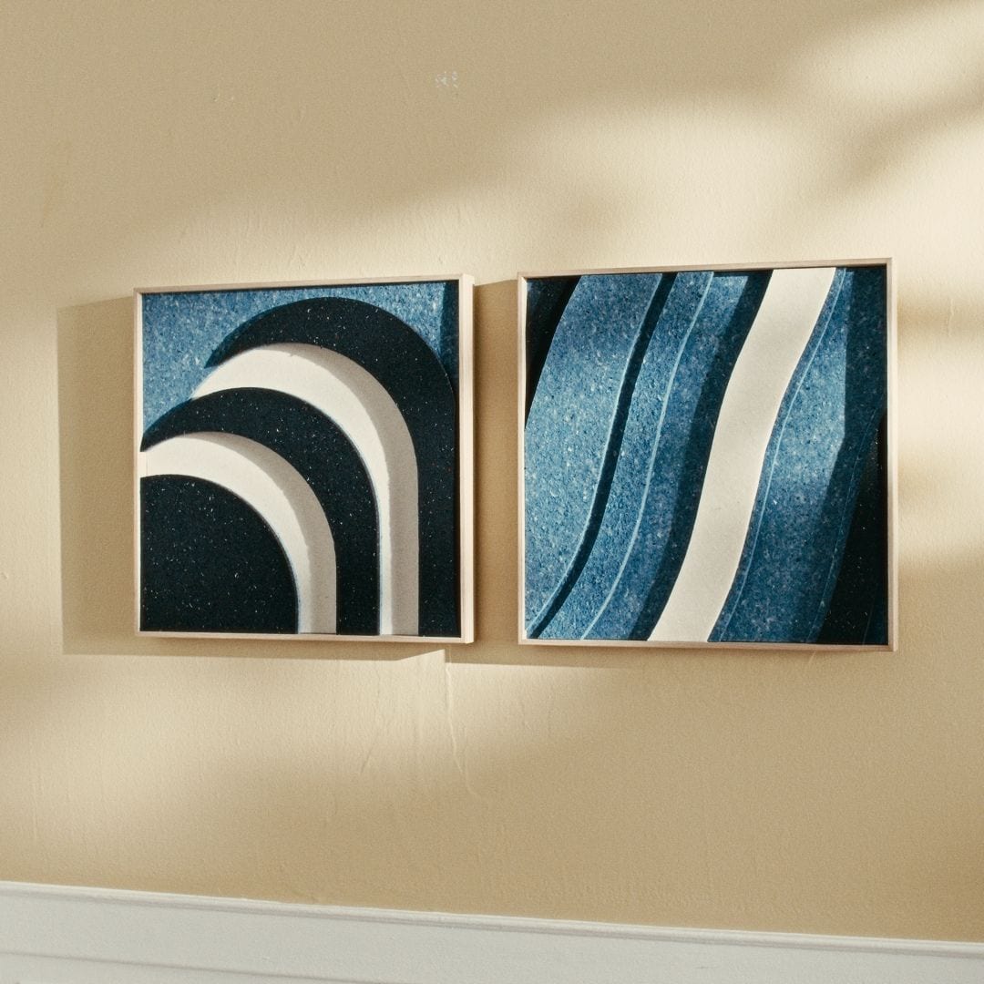 Modern acoustic wall panels crafted from recycled Danish Royal Guard uniforms, featuring blue and white wave and arch designs.